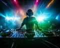 dj in concert in a flood of laser and strobe lights and in a light smoky haze, a magical club atmosphere full of colors