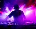 dj in concert in a flood of laser and strobe lights and in a light smoky haze, a magical club atmosphere full of colors