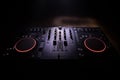 DJ console deejay-mixing desk in dark with colorful light. Mixer equipment entertainment DJ station Royalty Free Stock Photo