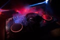 DJ console deejay-mixing desk in dark with colorful light. Mixer equipment entertainment DJ station Royalty Free Stock Photo