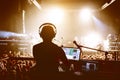 DJ with crowd of people in night club party under stage light Royalty Free Stock Photo