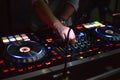 DJ desk in a nightclub party with hands. Studio DJ equipment glowing with light Royalty Free Stock Photo