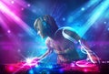 Dj girl mixing music with powerful light effects Royalty Free Stock Photo