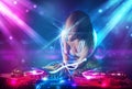 Dj girl mixing music with powerful light effects Royalty Free Stock Photo