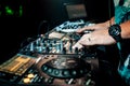 DJ hand mixes on a professional mixer controller at a concert Royalty Free Stock Photo