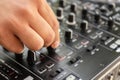 DJ hands creating and mixing music on DJ console mixer in a concert party outdoors Royalty Free Stock Photo