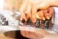 DJ hands creating and mixing music on DJ console mixer on a concert party outdoors Royalty Free Stock Photo