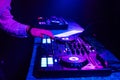 DJ hands mix music on a mixing Board in a nightclub