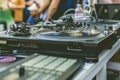 Dj hands play music vibes on a summer beach party using a vintage deck setup turntable