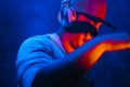 DJ with headphones playing mixing music at night party under the Royalty Free Stock Photo