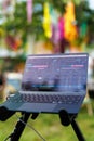 A DJ laptop with music editing software in a colorful outdoor festival Royalty Free Stock Photo