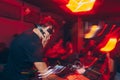 DJ mixer in a nightclub with moving motion abstract continuous lines glowing colored lights from controllers and buttons in the ni