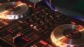 DJ mixes songs on equipment, hands closeup