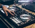 Dj mixing music track by hand on turn table