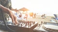 Dj mixing at sunset beach party in summer vacation outdoor - Disc jockey hands playing music for tourist people in chiringuito