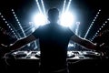 Dj in a nightclub scene with lights and lasers. Night scene of electronic music over the audience and crowd Royalty Free Stock Photo