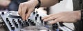 Horizontal banner or header with Dj mixing music outdoor at beach party festival - Close up of sound mixer equipment - Focus on ha Royalty Free Stock Photo