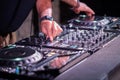 Dj playing disco house progressive electro music at the concert. DJ hands on equipment Royalty Free Stock Photo