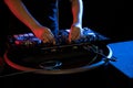 DJ playing turntable music on night club