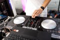 DJ plays live set and mixing music on turntable console at stage in the night club. Disc Jokey Hands on a sound mixer station at Royalty Free Stock Photo