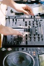 DJ plays music on the beach. Dj mixing beach party in summer vacation outdoor. Disc jockey hands playing music for
