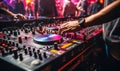 DJ\'s hand adjusting music on turntable at club party with dancing crowd in the background, vibrant nightlife scene Royalty Free Stock Photo