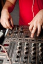 The DJ`s hand on the DJ mixer. Dj on the turntables. DJ`s hand on a DJ mixer close-up