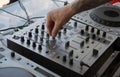 DJ`s hand on the music, control panel