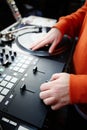 Dj scratching record with mixer and turntable player on concert stage