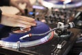 DJ scratching vinyl record on DJ turntable Royalty Free Stock Photo