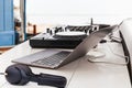 DJ sound control table mixing with headphone and laptop computer on table outdoors. Royalty Free Stock Photo