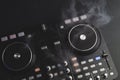 Dj sound mixer controller with knobs and sliders. audio mixing deck with turntables at dark with illuminated controls Royalty Free Stock Photo