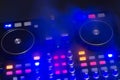 Dj sound mixer controller with knobs and sliders. audio mixing deck with turntables at dark with illuminated controls Royalty Free Stock Photo