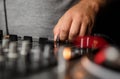 Dj sound mixer on stage. Disc jockey hand on cross fader knob Royalty Free Stock Photo