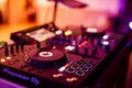 DJ Spinning, Mixing, and Scratching in a Night Club. DJ playing music at mixer . Closeup. Party. Royalty Free Stock Photo