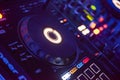 DJ Spinning, Mixing, and Scratching in a Night Club. DJ playing music at mixer . Closeup. Party. Royalty Free Stock Photo