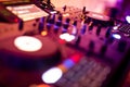 DJ Spinning, Mixing, and Scratching in a Night Club. DJ playing music at mixer . Closeup. Party. Royalty Free Stock Photo