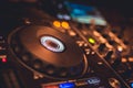 DJ Spinning, Mixing, and Scratching in a Night Club. DJ playing music at mixer . Closeup. Party. Royalty Free Stock Photo