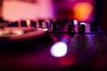 DJ Spinning, Mixing, and Scratching in a Night Club. DJ playing music at mixer . Closeup. Party. Royalty Free Stock Photo