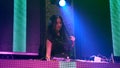 DJ on stage in disco night club mixing techno music beat