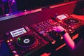 DJ turntable console mixer controlling with two hand in concert nightclub stage. Royalty Free Stock Photo