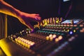 DJ turntable console mixer controlling with two hand in concert nightclub stage. Royalty Free Stock Photo