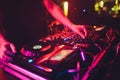 DJ turntable console mixer controlling with two hand in concert nightclub stage. Royalty Free Stock Photo