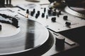 Dj turntable turntable playing vinyl disc with hip hop music.Closeup, focus on needle cartridge headshell. Royalty Free Stock Photo