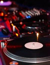 Dj turntables needle cartridge on black vinyl record with music. Close up, focus on turntable and audio disc record Royalty Free Stock Photo