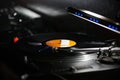 Dj turntables needle cartridge on black vinyl record with music. Close up, focus on turntable and audio disc record Royalty Free Stock Photo