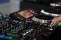 DJ using a sound mixer controller to play music Royalty Free Stock Photo
