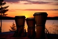 djembe drums silhouette against a sunset