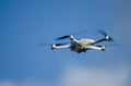 DJI Mavic Mini 3 drone in flight, blue sky in the background