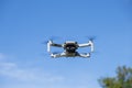Dji Mavic Mini drone flying on a blue sky day